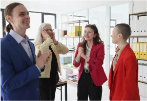 Colleagues laughing together in an office